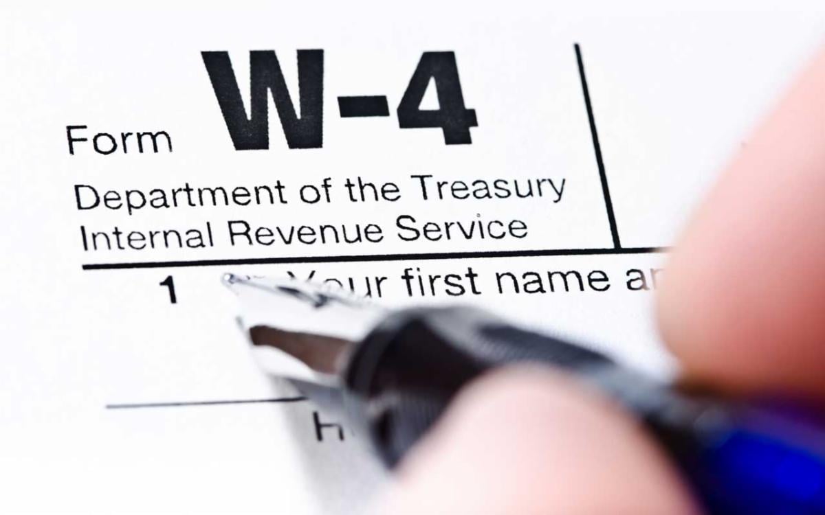 An employee fills out a W-4 form. It's important to stay informed on the latest forms to know how they impact employees and to ensure compliance.